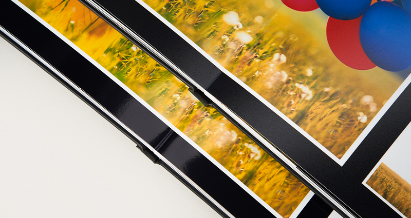 Comparison of photographic papers in a panoramic photo book that opens flat.