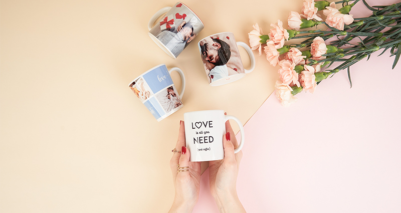 A woman holds a personalised photo mug with a photo.
