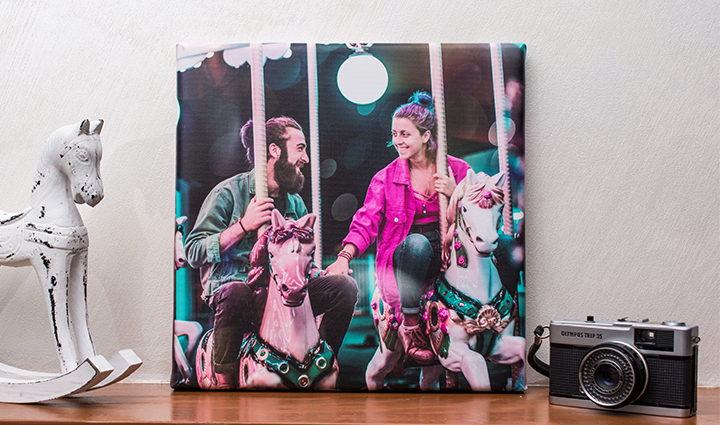 Sur une étagère une toile photo  avec un couple dans un parc d’attraction.