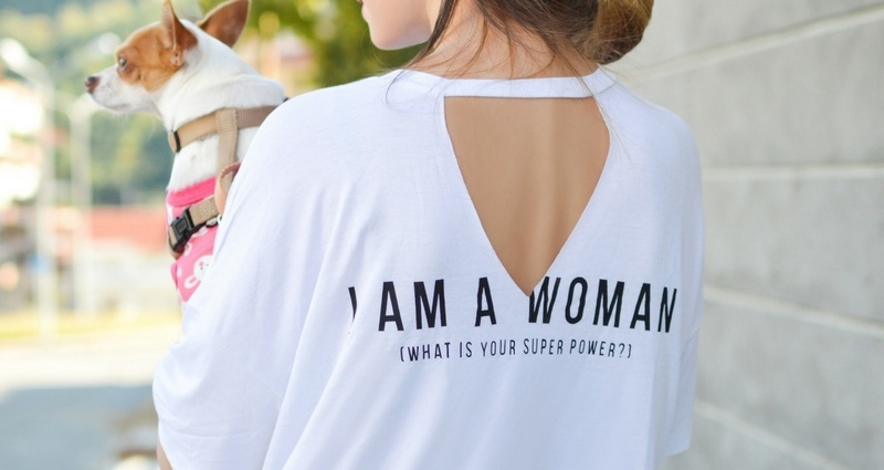 Woman in a t-shirt with inscription on the back "I'm a woman, what's your superpower?"